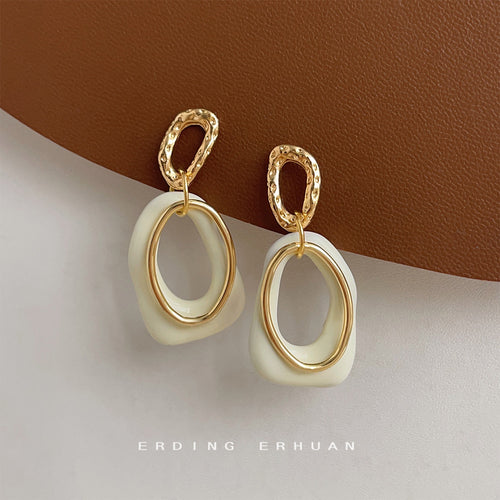 Gold-tone cream-white open sculpted drops in the first product display.