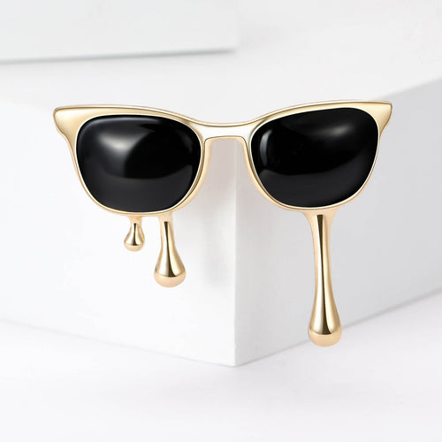 Angled view showing glossy black enamel and gold or silver tone metal