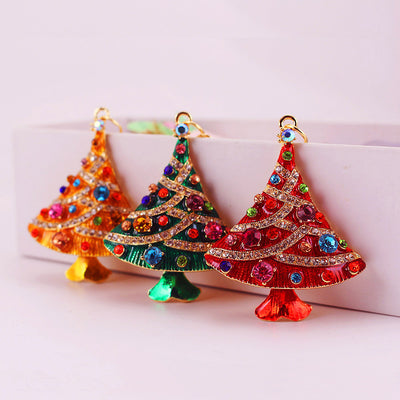 Three red, green and gold rhinestone Christmas tree charms displayed side by side.