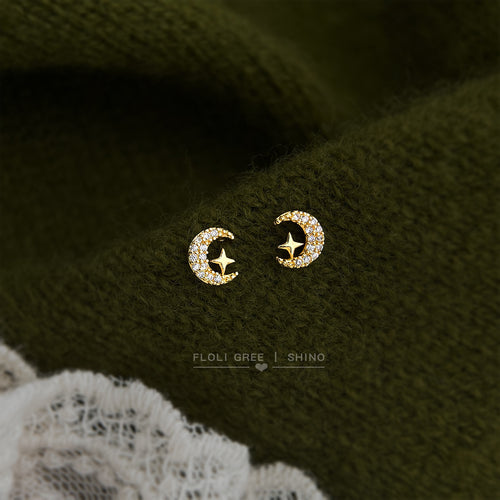 Gold-tone clear-stone crescent open-star studs in the first product display.