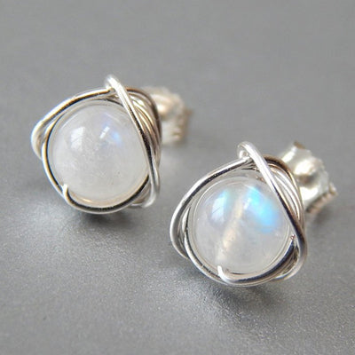 Wire wrap moonstone look studs on gray surface with backs visible