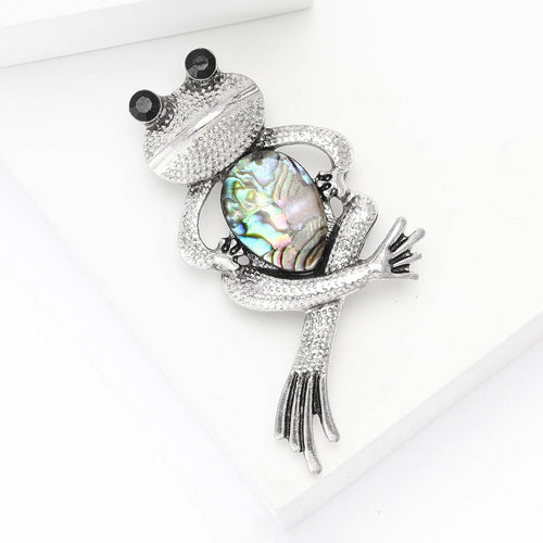 A frog with crystal details and an iridescent shell body shown in a styled display.