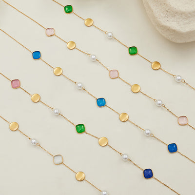 Grouped style view of cat eye and imitation pearl station necklaces in main image 1.
