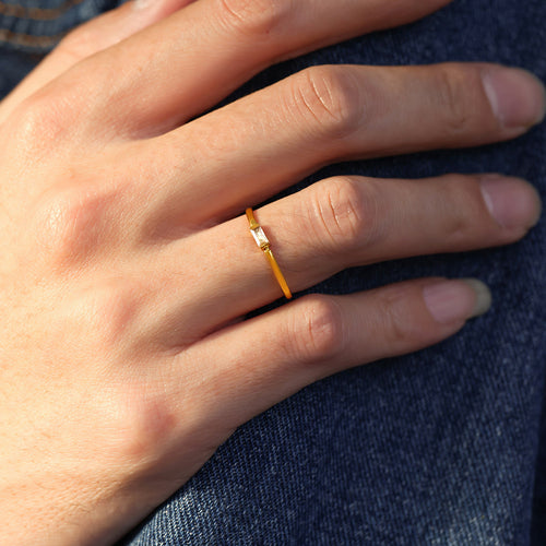 Grouped style view of gold tone rectangular solitaire slim ring in main image 2.