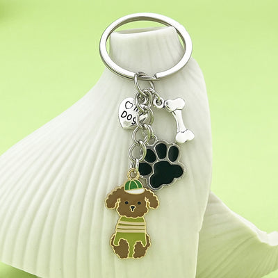 Image 1 showing a key chain with a dog and cat on it.