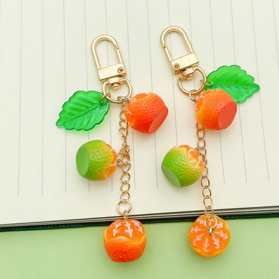 Image 1 showing citrus fruit keychains shown in the product image.