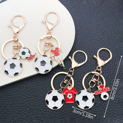 Front product photo of soccer player medal jersey and shoe enamel keychain showing the pictured design arrangement