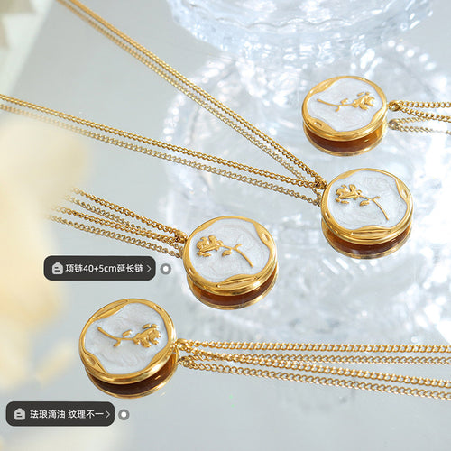 Multiple gold rose enamel disc pendants on mirror with size labels
