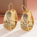 Gold Tone Wide Hoop Earrings With Black Floral Line Art view 1
