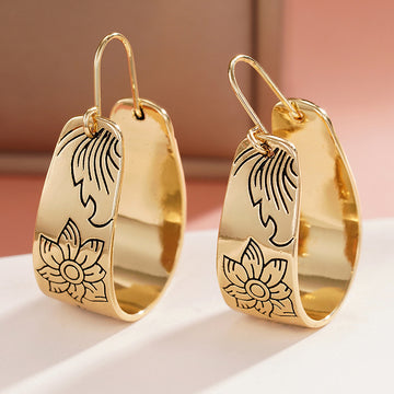 Gold Tone Wide Hoop Earrings With Black Floral Line Art