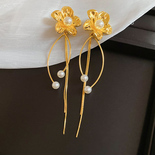 Gold Tone Flower Stud Earrings with Long Chain Fringe shown in a display view