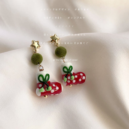 Gold star green pom Christmas stocking drops on white fabric