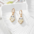 Gold Tone Pressed Flower Hamsa Huggie Earrings in Nine Options view 11