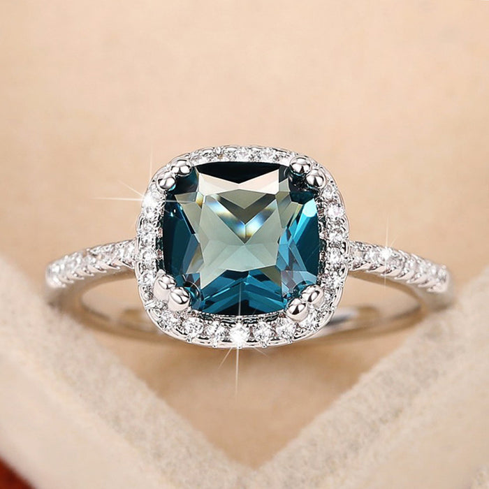 Deep Blue Cushion Solitaire Halo Ring In Polished Silver Tone