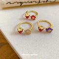 Gold Open Rings With Red Strawberry And Enamel Flower Ends view 2