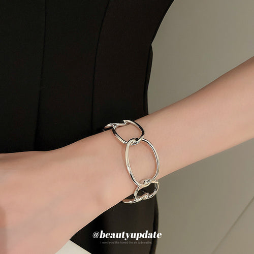 rounded oval-link open cuff bracelet in silver-tone or gold-tone finishes shown in the first close product view