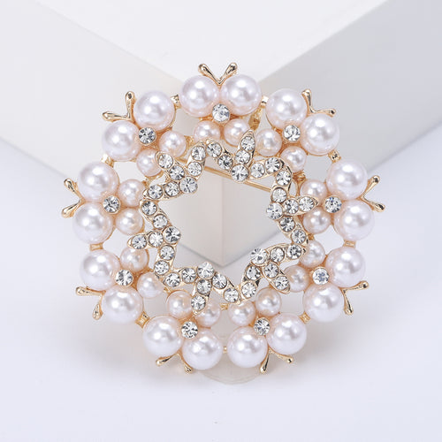 Angled view showing the floral wreath brooch surface