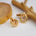 Twelve Gold Tone Sculptural Knot and Hoop Earrings view 1
