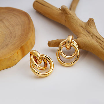 Twelve Gold Tone Sculptural Knot and Hoop Earrings