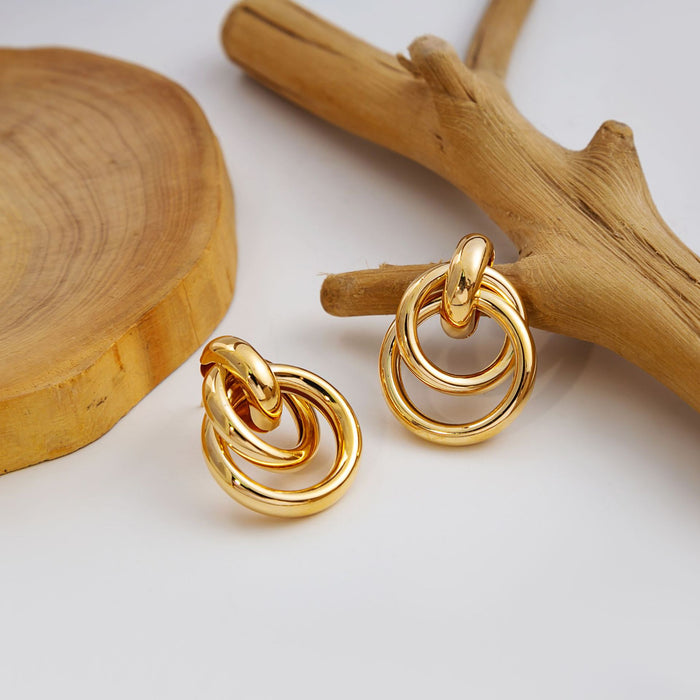Twelve Gold Tone Sculptural Knot and Hoop Earrings