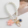 Pearl Beaded Wristlet Keychain with Evil Eye and Glitter Flower Charm view 4