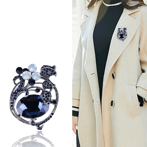 Close front view showing a dark floral frame surrounding an oversized faceted oval stone
