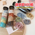 Tube Of One Hundred Thin Elastic Hair Ties In Black Or Pastel Colors view 2