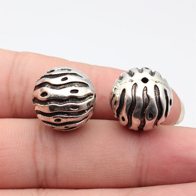 Front fingertip view of 波浪纹球形珠 showing its visible shape and finish