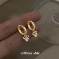 Gold Tone Crystal Pave Huggie Hoop Earrings Bow Drop view 4