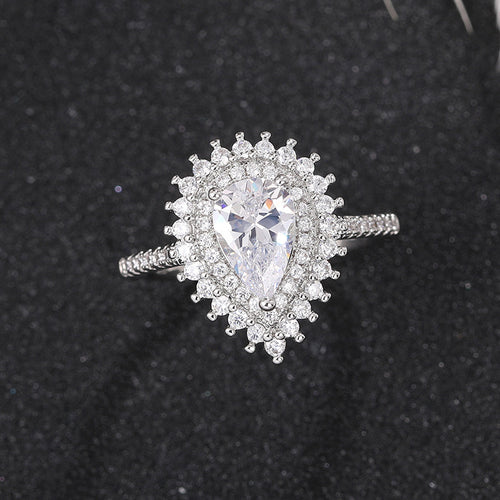 Side view of silver tone pear center halo ring