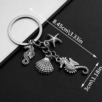 Front product photo of antique silver seahorse starfish and shell ocean charm keychain showing the pictured design arran