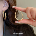 Slim Oval Statement Hoop Earrings in Gold and Silver Tones view 3