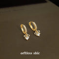 Gold Tone Crystal Pave Huggie Hoop Earrings Bow Drop view 1