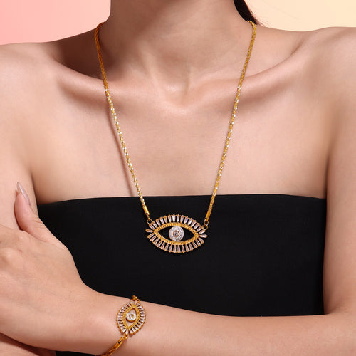 Model wearing gold evil eye baguette pendant necklace with matching bracelet
