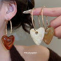 Gold Tone Hoop Earrings with Resin Heart Drops in Three Colors view 1