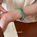 Brown Segmented Closed Bangle And Nine Wavy Open Resin Cuffs view 3