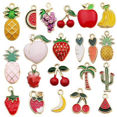 Colorful strawberry and banana charms arranged on a light background