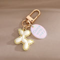 Gold Tone Balloon Dog Clip Keychains with Pearl Collars and English Tags view 2
