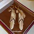 Gold Layered Feather Huggie Earrings with Cutout Details view 4