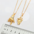 Gold Tone Hand Gesture Pendant Necklaces in Two Distinct Designs view 2