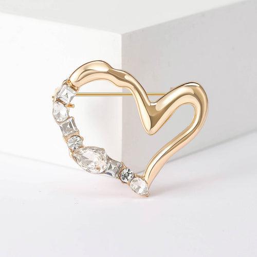 Close-up product view showing the colors and surface details of the asymmetric double heart brooch