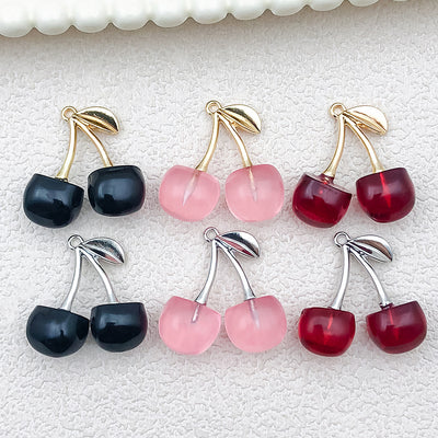 Multicolor cherry charms arranged on a light background