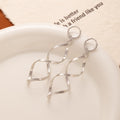Gold and Silver Spiral Ribbon Hook and Huggie Earrings view 9