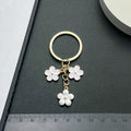 White Sakura Flower Enamel Charm Keychain with Gold Tone Ring view 4