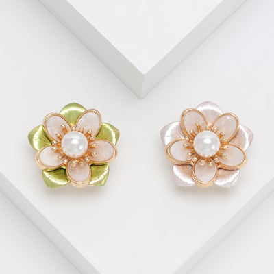 Front view of layered translucent camellia petals surrounding a pearl center