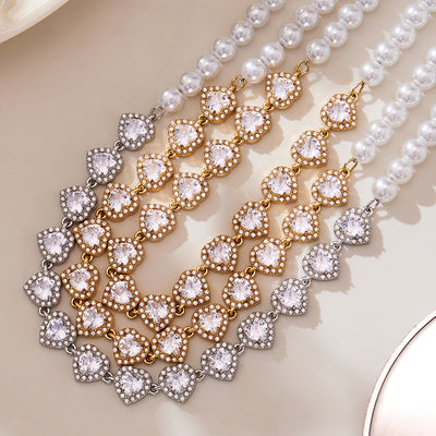 Grouped style view of pearl and crystal heart collar necklaces in main image 1.