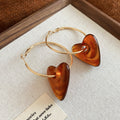 Gold Tone Hoop Earrings with Resin Heart Drops in Three Colors view 6