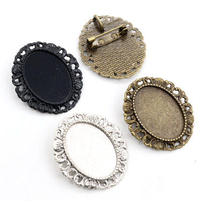 ornate oval cabochon brooch settings arranged together on a white background