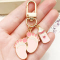 Eight Pink and Blue Baby Bottle Footprint Keychain Designs view 1