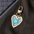 Gold Tone Swirled Heart Evil Eye Clip Keychains in Five Colors view 3